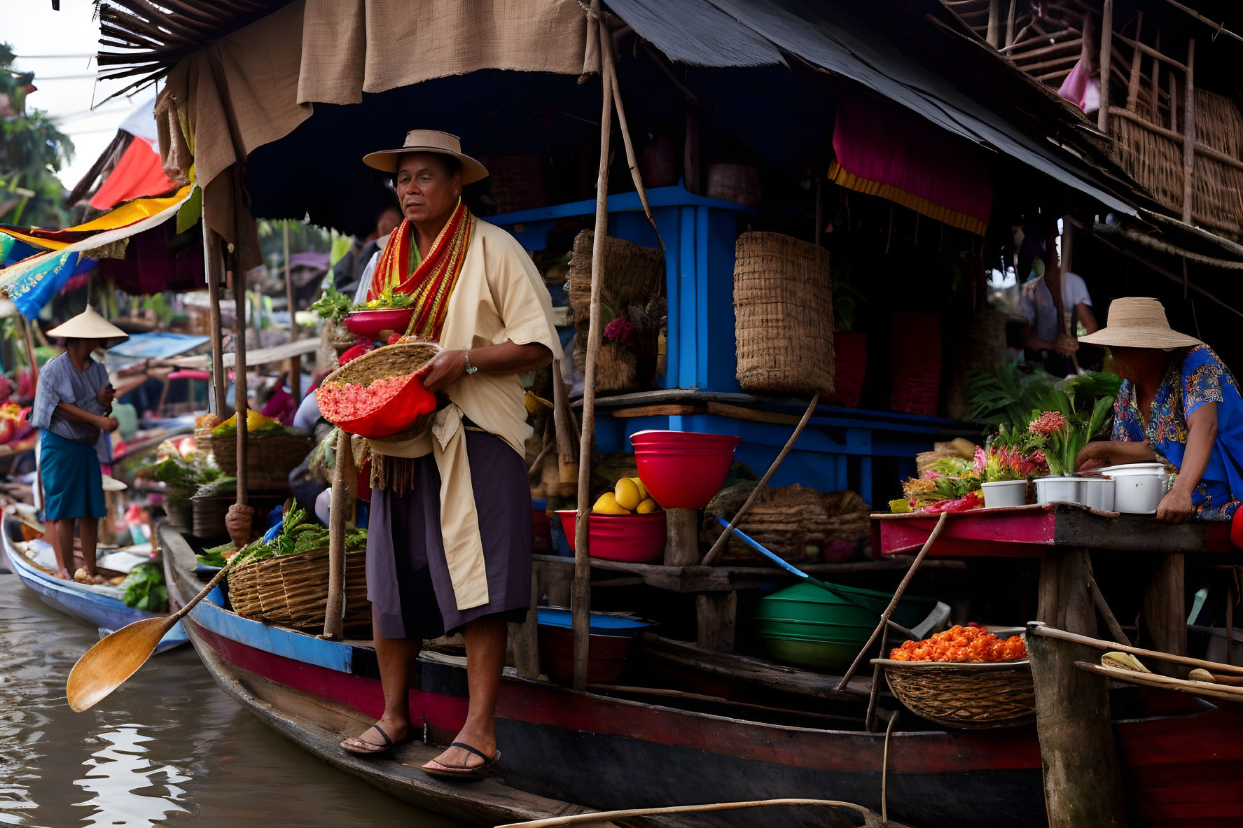 Person with red fruits on wooden boat in floating market surrounded by vendors