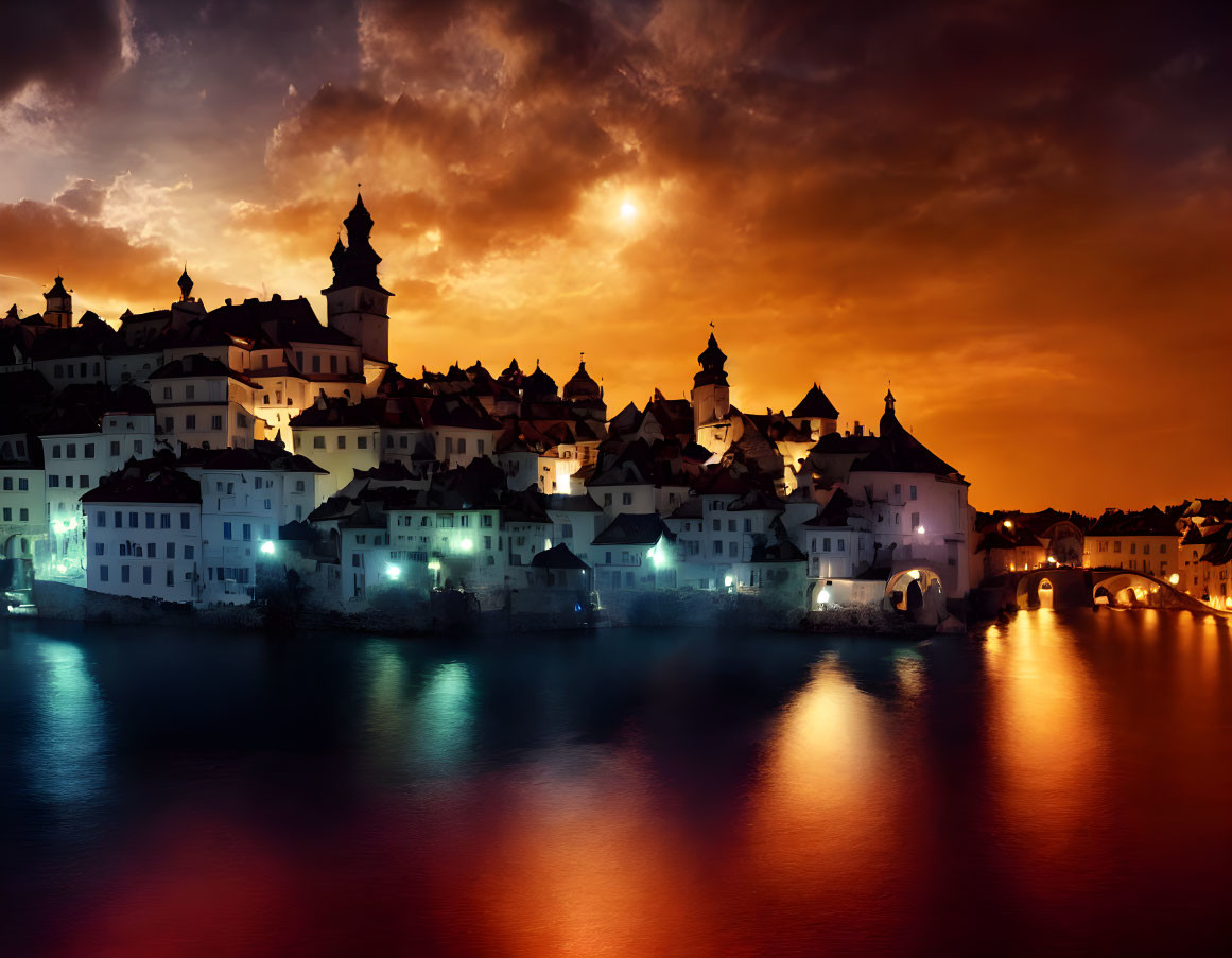 Night scene of illuminated town reflected in water under dramatic sky