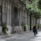 Vintage houses, blooming flowers, horse-drawn cart, and solitary figure on tranquil street