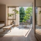 Sunlit conservatory with French door, balcony, elegant chairs, lush greenery, blooming flowers