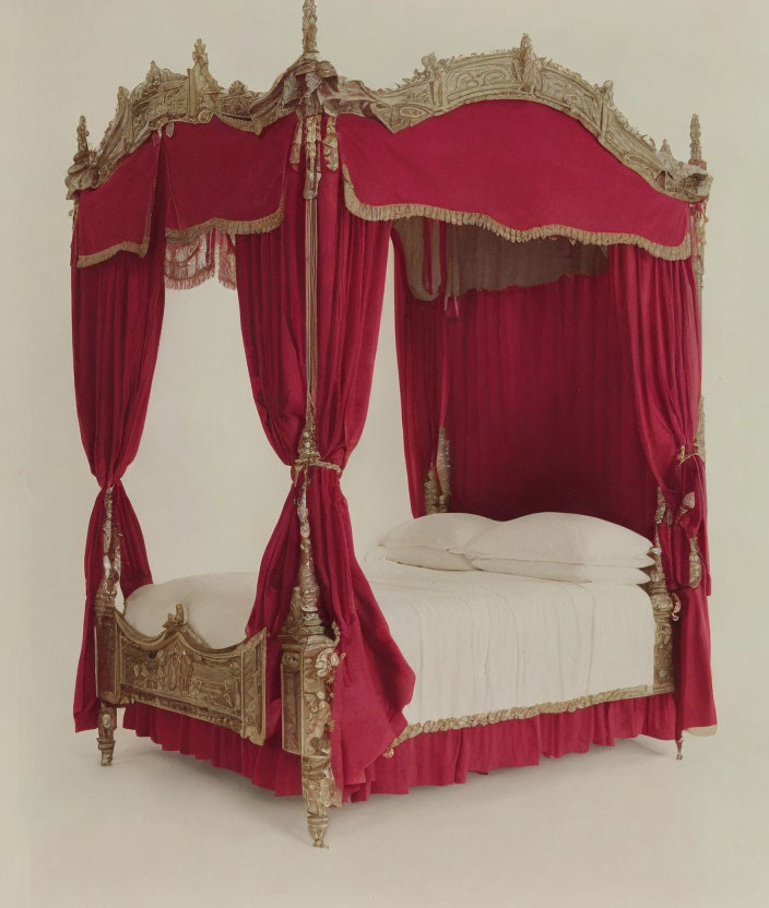 Antique Canopy Bed with Red Drapes and Gold Detailing