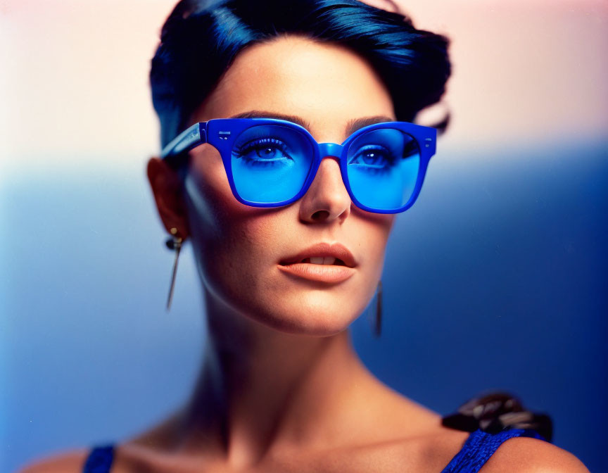 Short Haired Woman in Blue Glasses on Blue and Orange Background