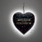 Stylized black heart with glossy finish and red hearts inside on gray background.