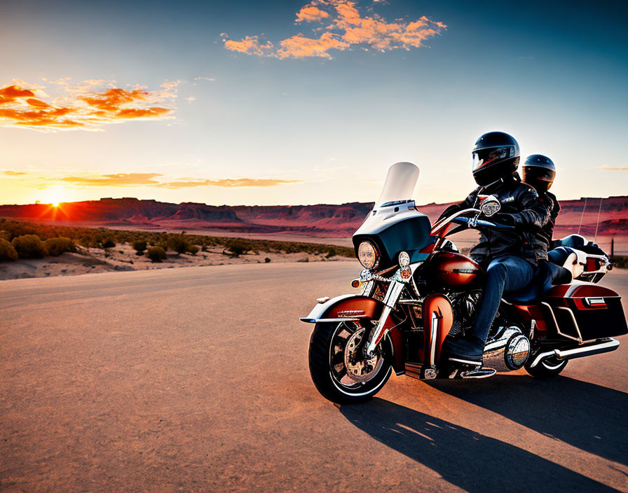 Two motorcyclists riding on a desert road at sunset with warm sunlight.