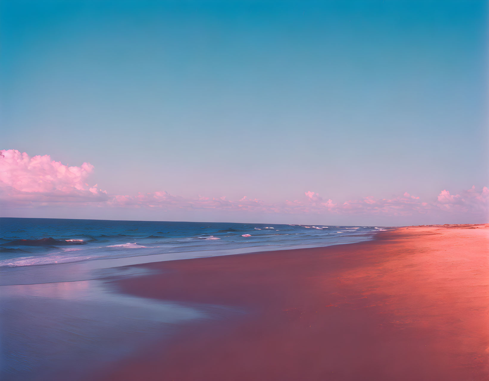 Tranquil sunset beach scene with pink and blue hues