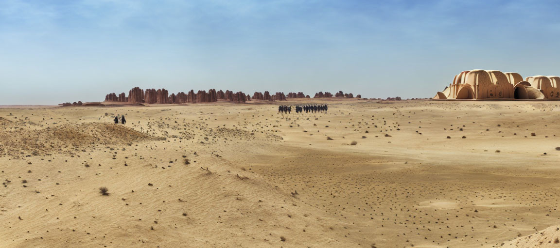 Desert landscape with sand dunes, rock formations, and people exploring under clear sky