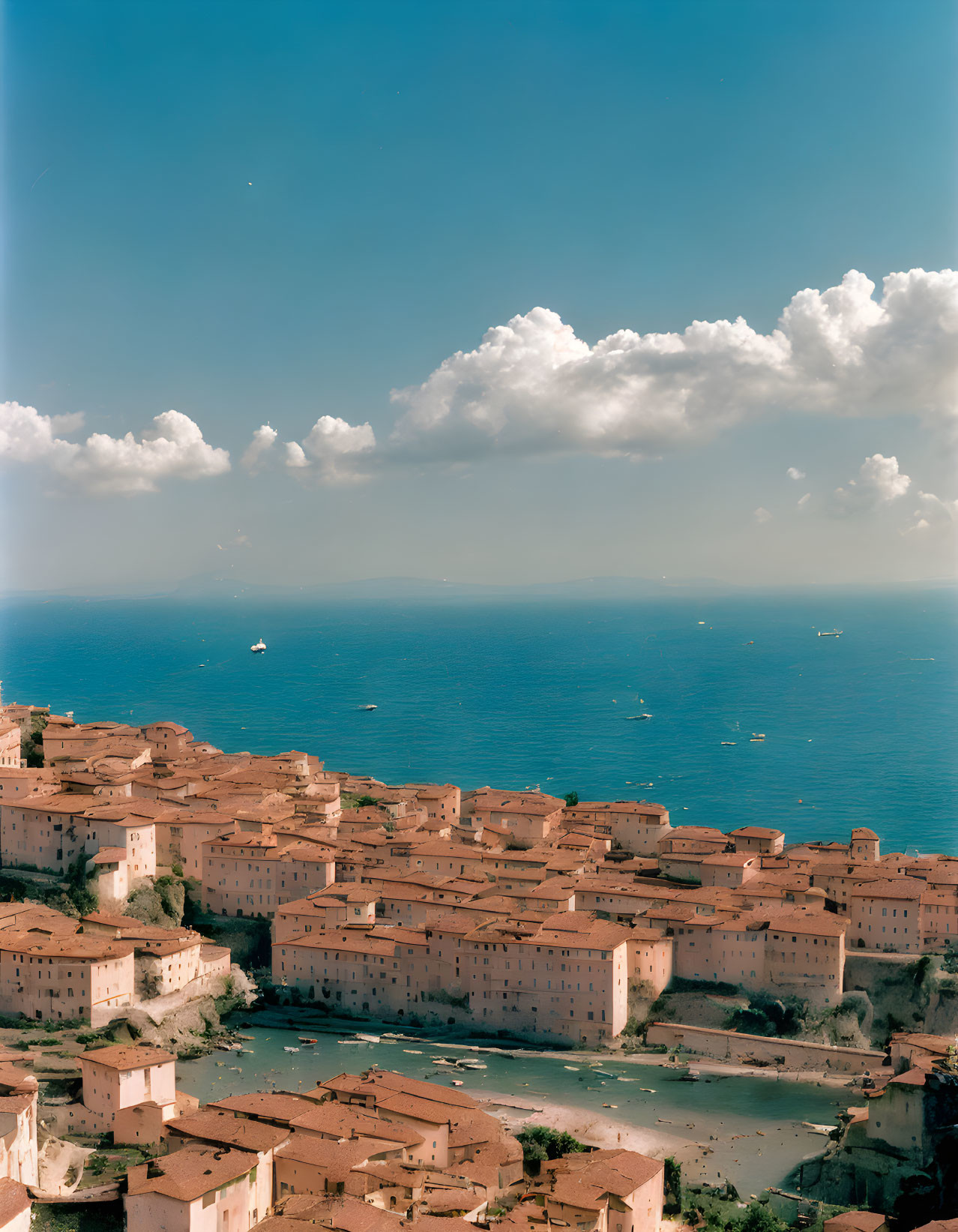 Mediterranean coastal town with terracotta roofs and blue sea