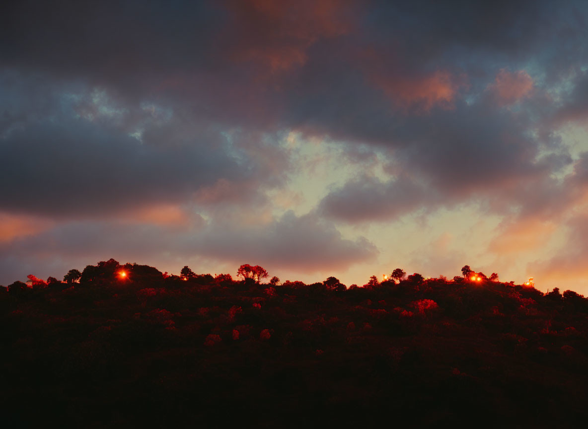 Fiery Dusk Sky Silhouettes Forested Hillside