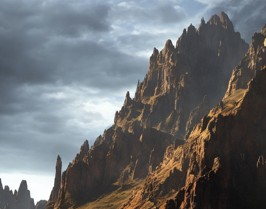 Dramatic shadows on majestic mountain peaks under moody sky