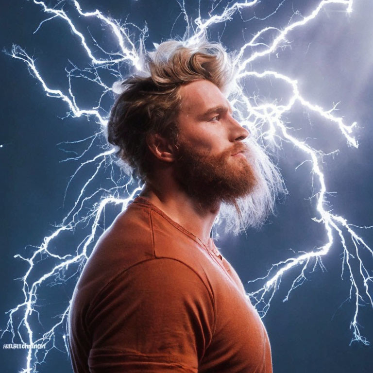 Bearded man with tousled hair in orange shirt with lightning bolts on blue background