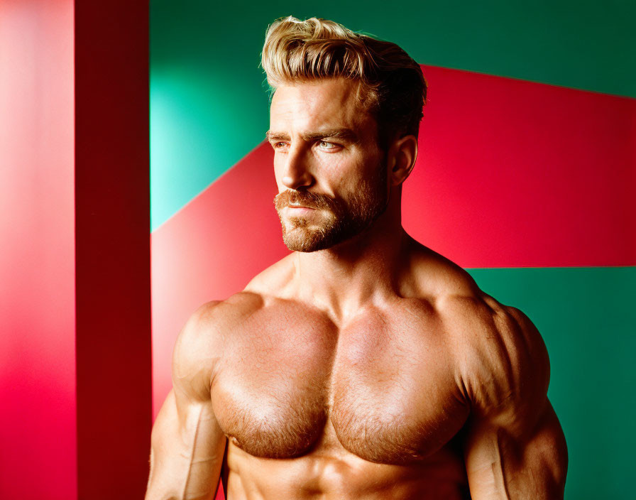 Bearded man posing against colorful geometric backdrop