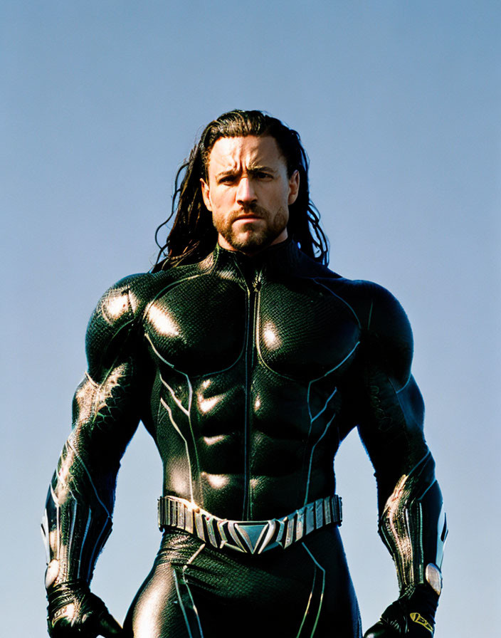 Black textured superhero costume against clear blue sky