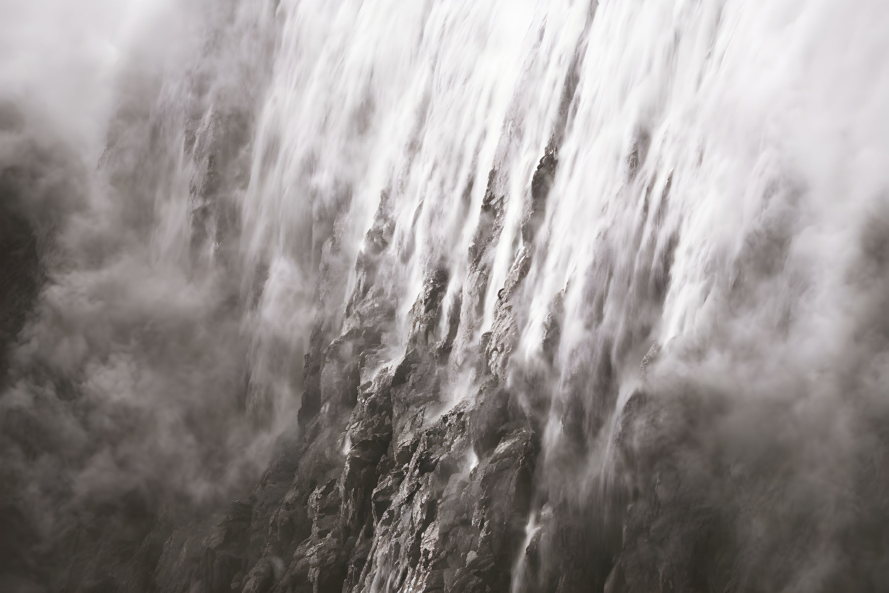 Majestic waterfall cascading over jagged rocks