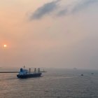 Historic sail ships in mist and smoke on tumultuous seas