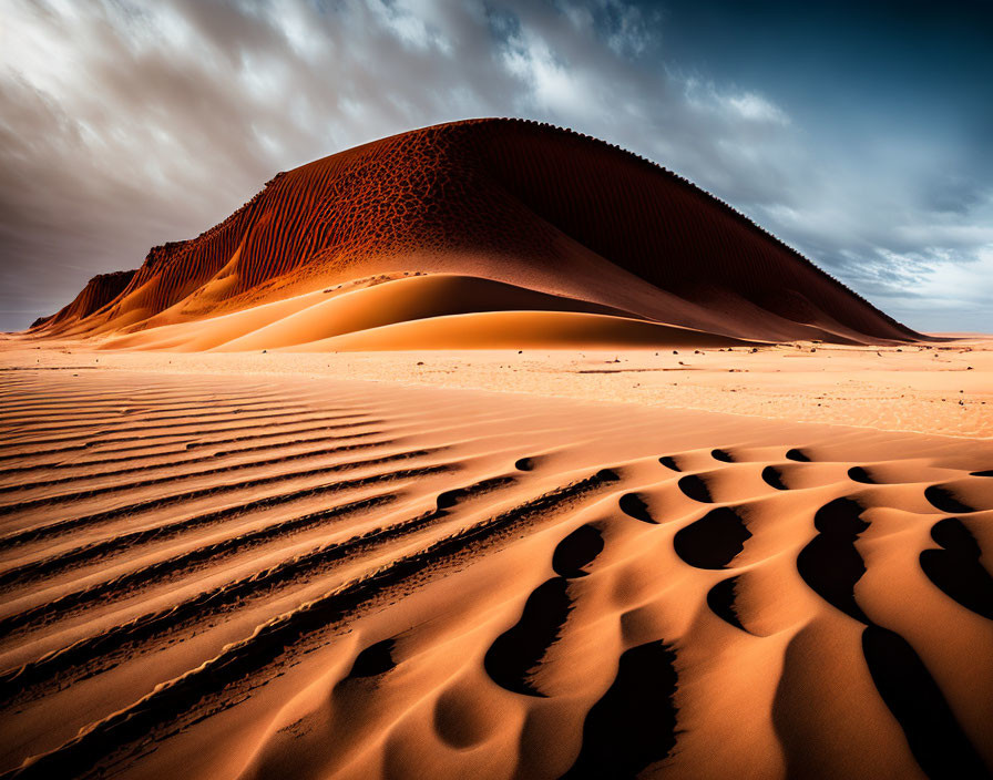 Dramatic desert landscape with rippled sand dunes and striking sky contrast