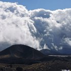 Panoramic landscape with dramatic storm clouds and fiery lava ground