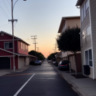 Vintage cars parked on tranquil suburban street at sunset