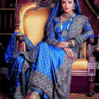 Traditional Indian Woman in Blue and Gold Saree on Ornate Chair