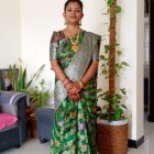 Traditional Green Saree with Gold Motifs and Elegant Jewelry