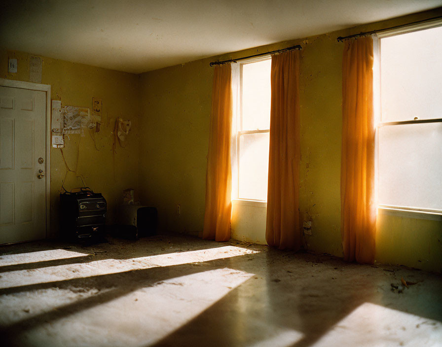 Dimly Lit Empty Room with Orange Curtains and Shadows