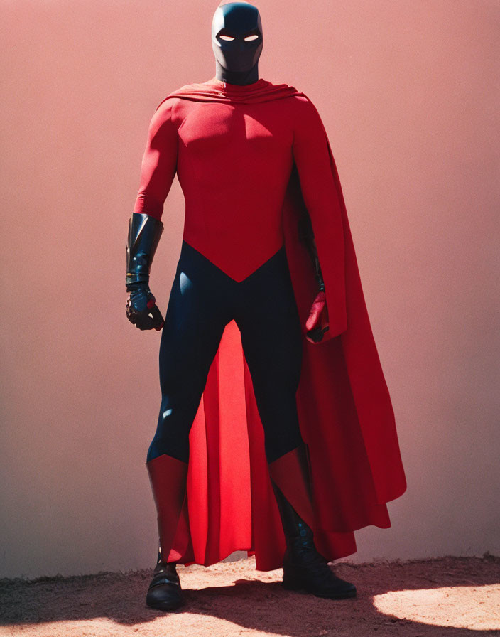 Red Superhero Costume with Cape, Mask, and Robotic Arm on Pink Background