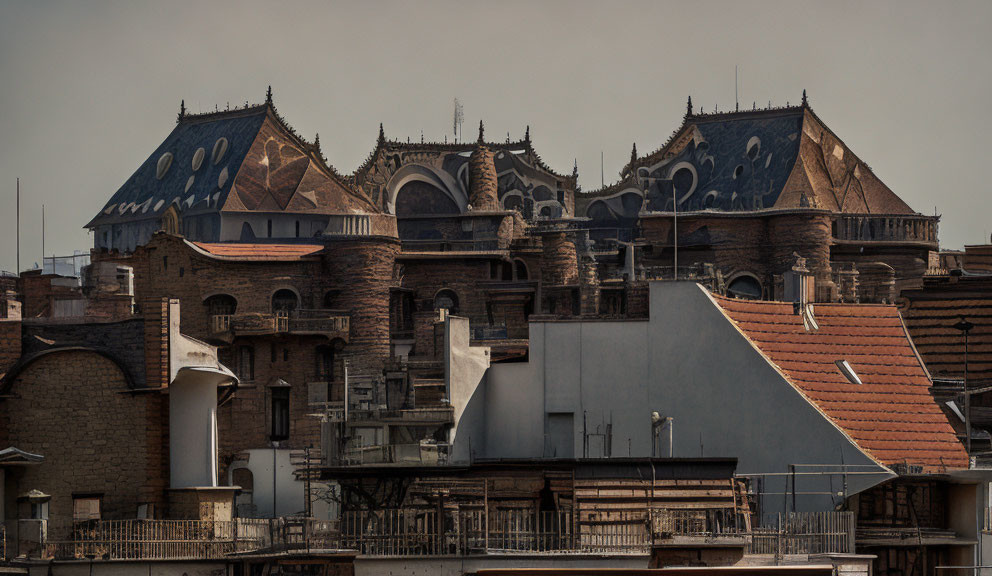 European-style building with ornate curved rooftops and patterned tiles under a moody sky.