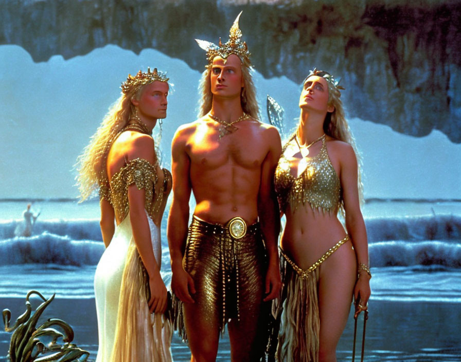 Three people in fantasy costumes against icy backdrop in metallic & white attire.