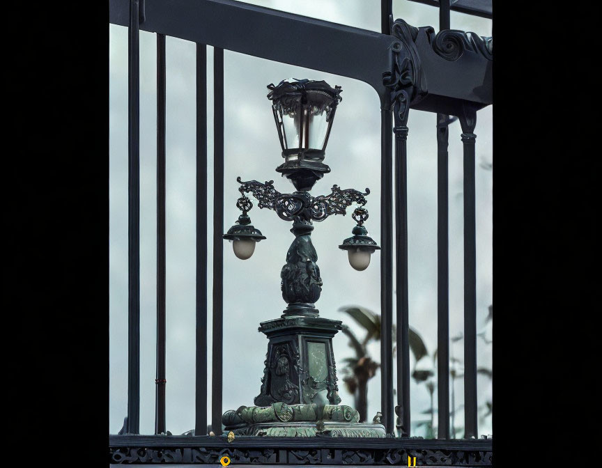 Ornate street lamp with multiple lights against cloudy sky