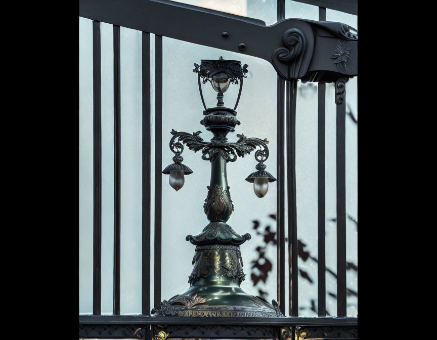 Intricate metalwork street lamp against blue sky