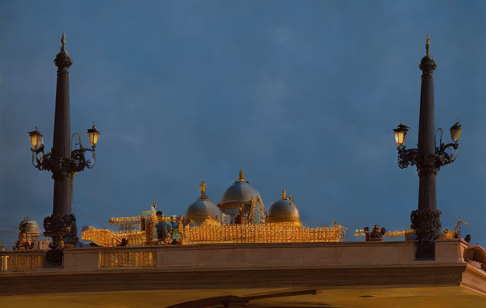 Ornate lampposts and bridge railing in twilight scene with domed structures and admiring