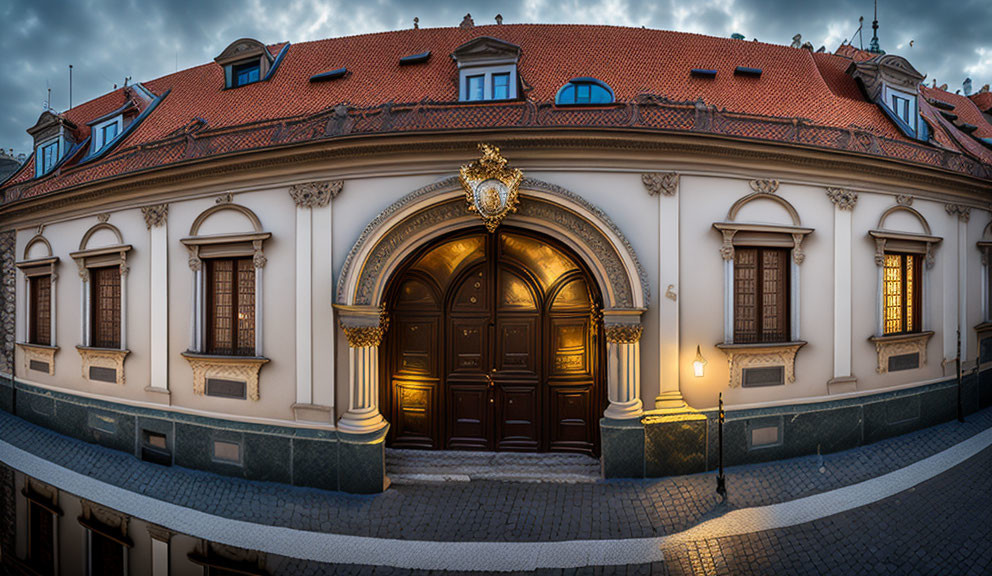 Traditional European Building with Ornate Golden Crest and Red Tiled Roof