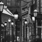 Cloaked figure in snowy, lantern-lit street at night