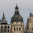 European Buildings with Dome and Spire Rooftops in Cloudy Sky