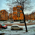 Vintage cars and elegant buildings in snowy city twilight scene