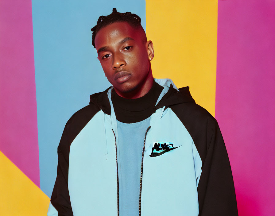 Braided Hair Man in Nike Jacket on Colorful Backdrop