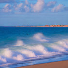 Scenic beach landscape with blue sea and crashing waves