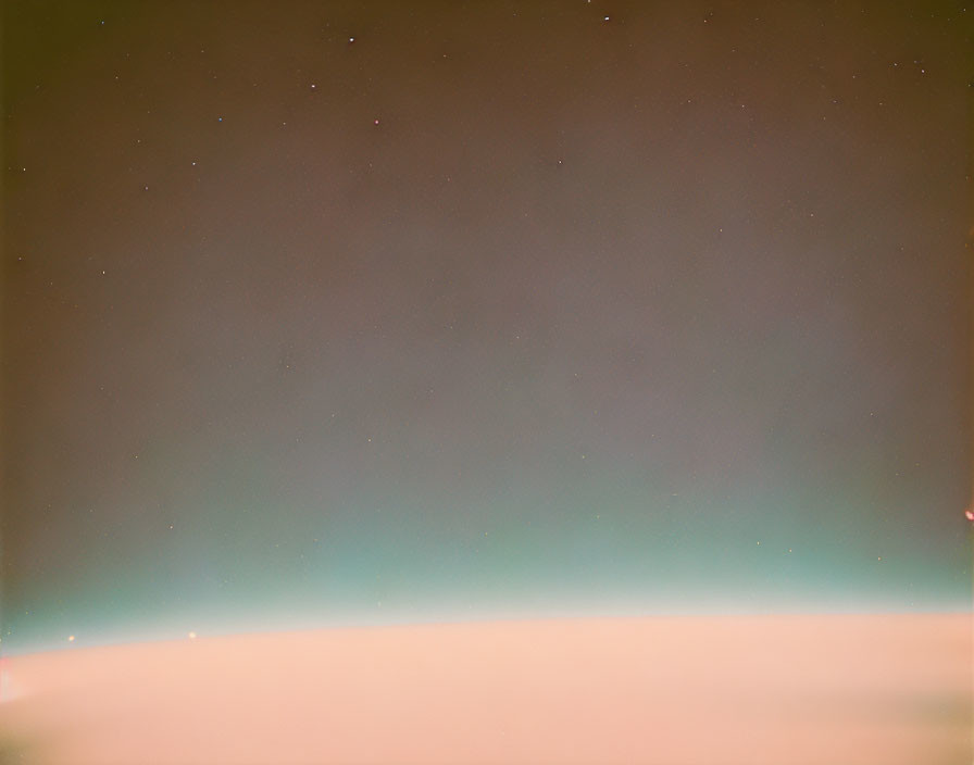 Subtle aurora night sky with soft horizon and bright stars