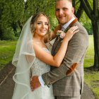 Bride and Groom Embrace Under Green Leaf Canopy