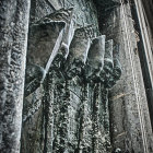 Turquoise Door with Classical Face Relief Sculptures and Falling Snowflakes