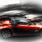 Stylized red sports car with motion-blurred supercars on monochromatic background