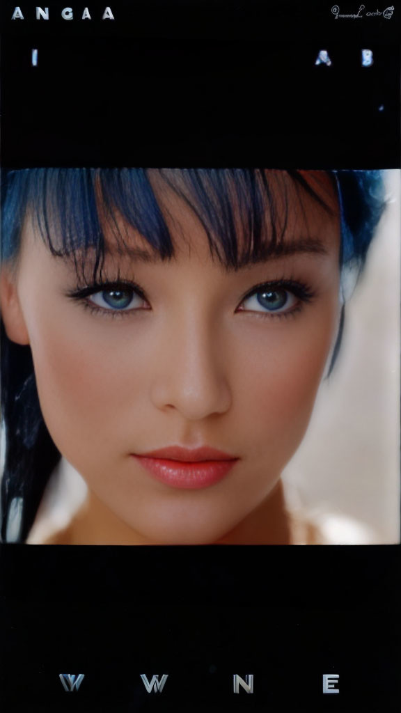 Close-up portrait of woman with blue hair, bangs, subtle makeup, pink lips