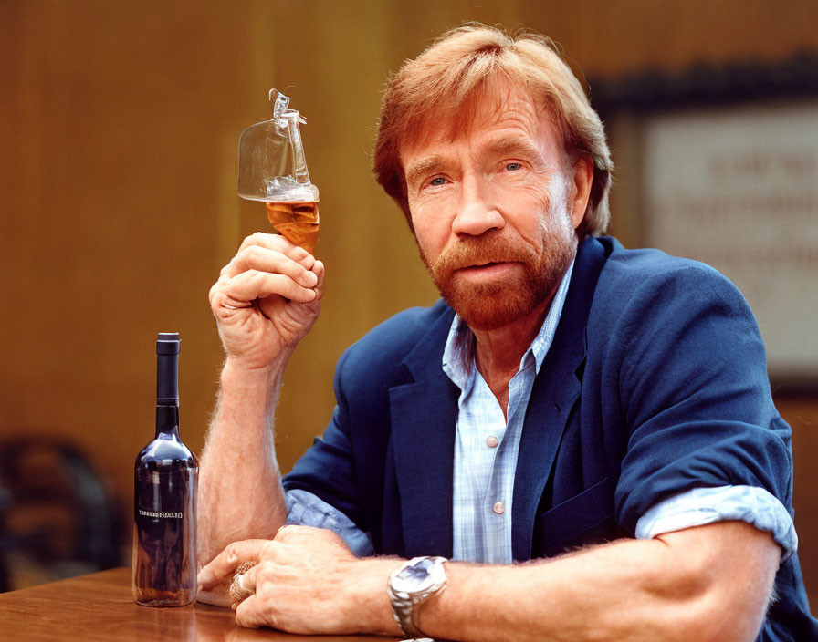 Bearded man smiling with whisky glass and bottle on table