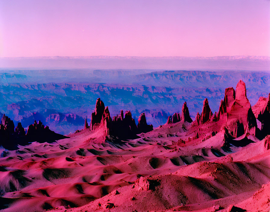 Surreal landscape with purple hues and jagged rock formations against canyon backdrop