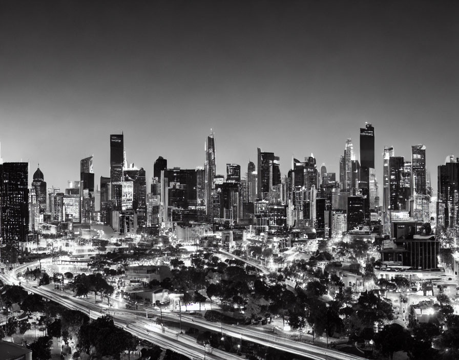 Cityscape at Dusk: Black & White Buildings, Busy Streets