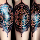 Geometric tattoo on arm with abstract patterns in black, gold, and red colors