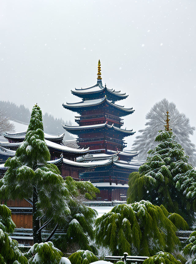 Traditional multi-tiered pagoda in snow-covered landscape