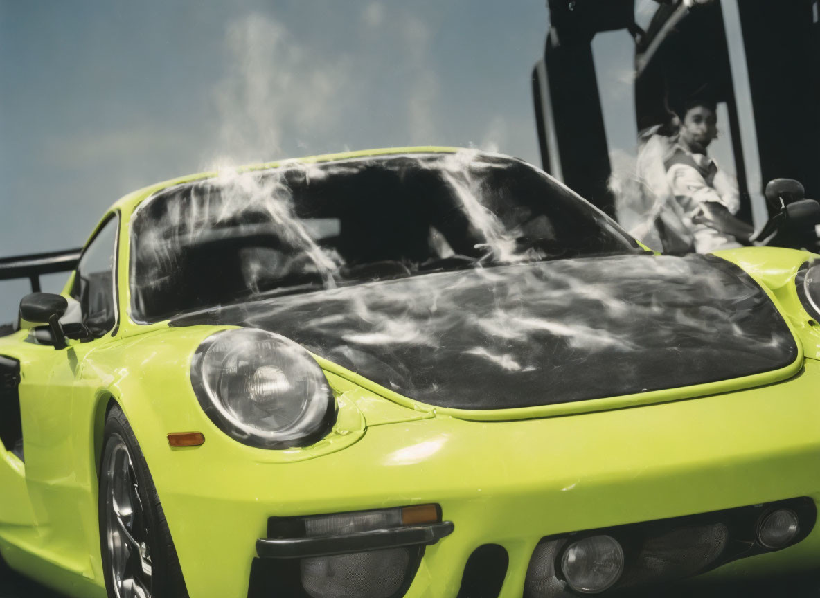 Bright Green Sports Car with Glossy Finish and Steam, Person Partially Visible