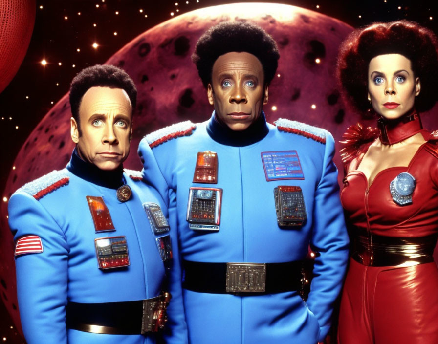 Three actors in blue futuristic space uniforms with medals against a starry sky and a red planet.