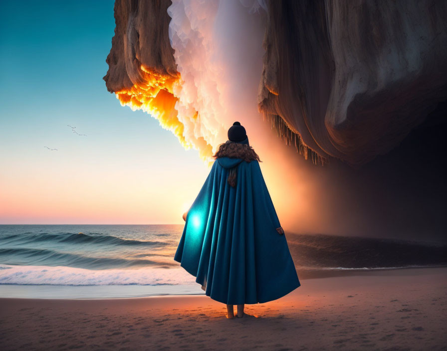 Person in Blue Cloak Contemplating Fiery Phenomenon on Beach