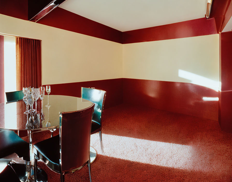 Sophisticated dining room with red and tan walls, glass table, and green chairs